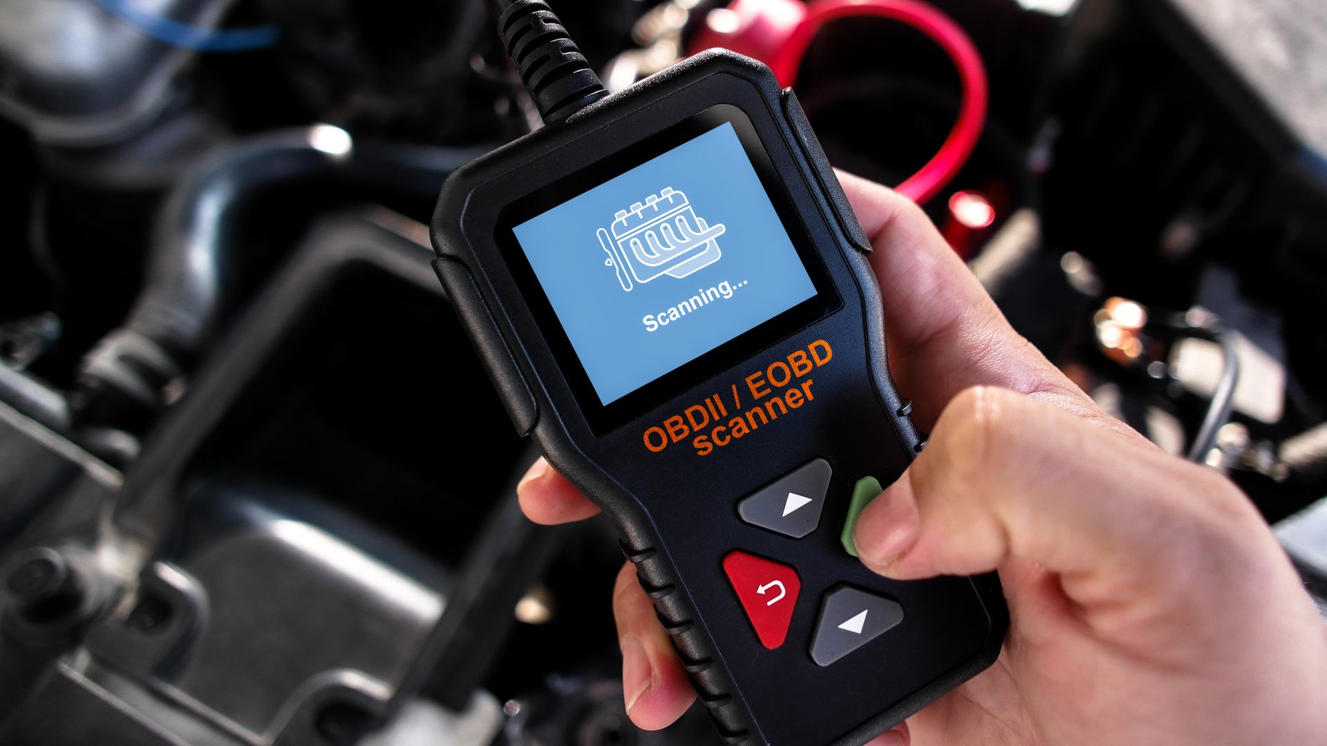 OBDII scanner performing diagnostic scan on vehicle's engine