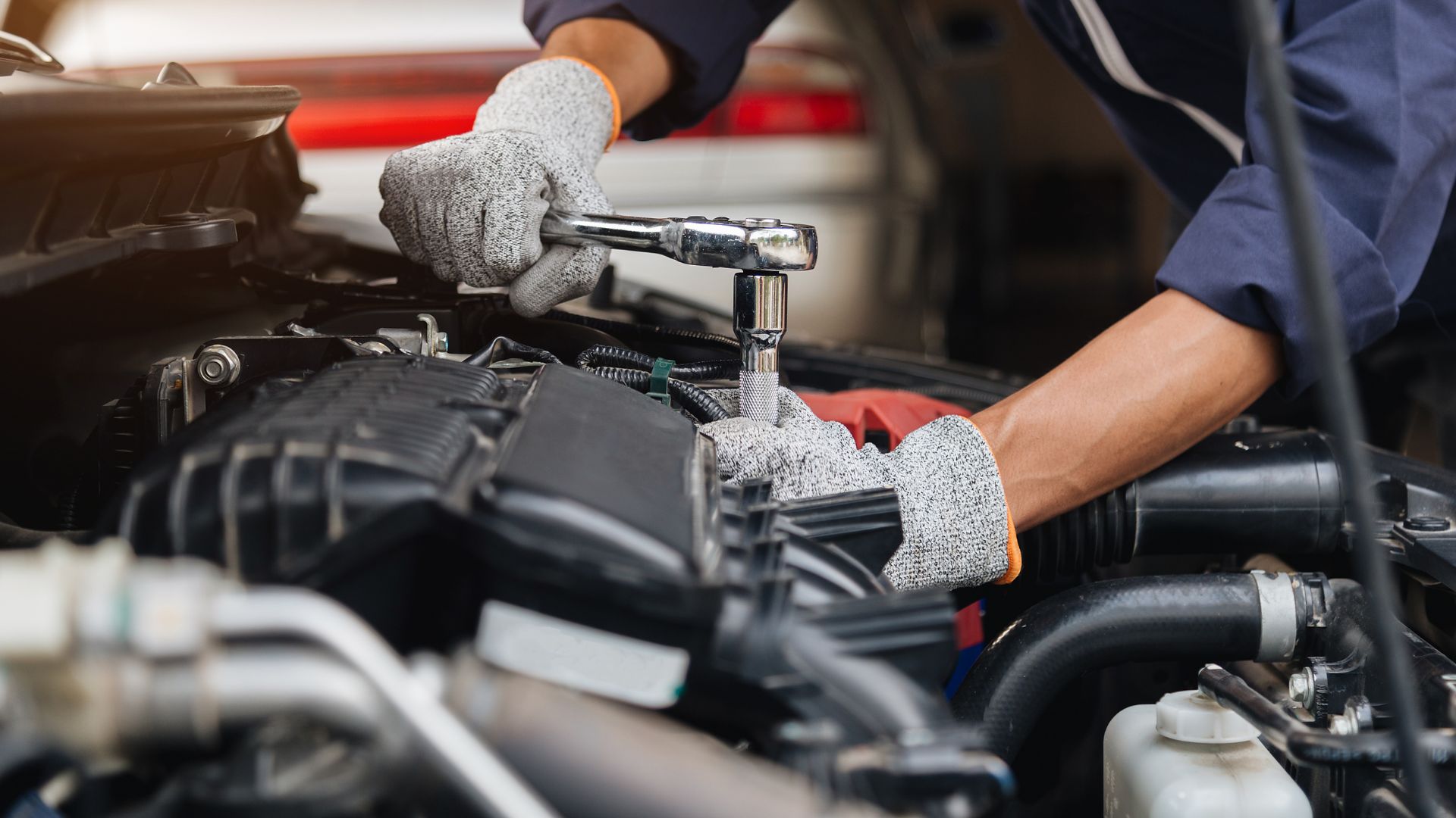 Mechanic using a wrench to repair a car engine