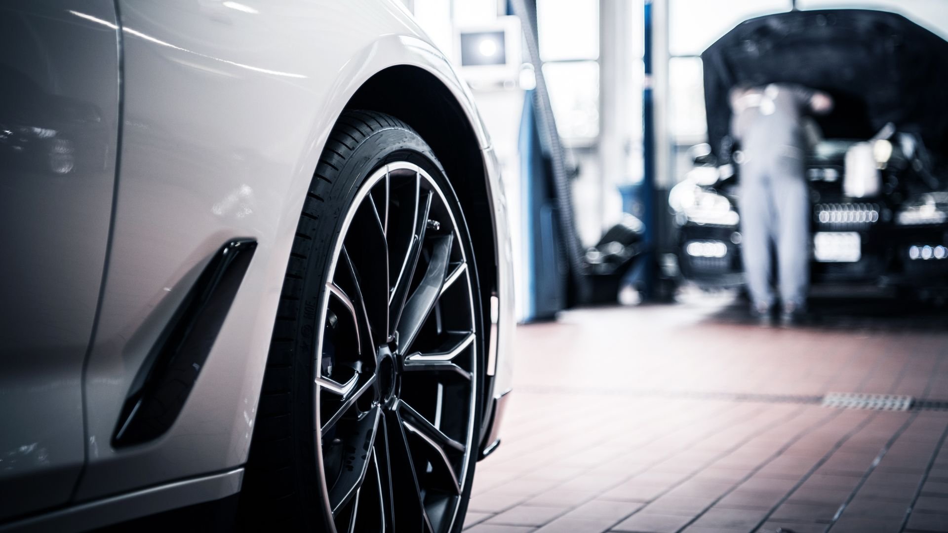 Modern car wheel and rim in automotive service center